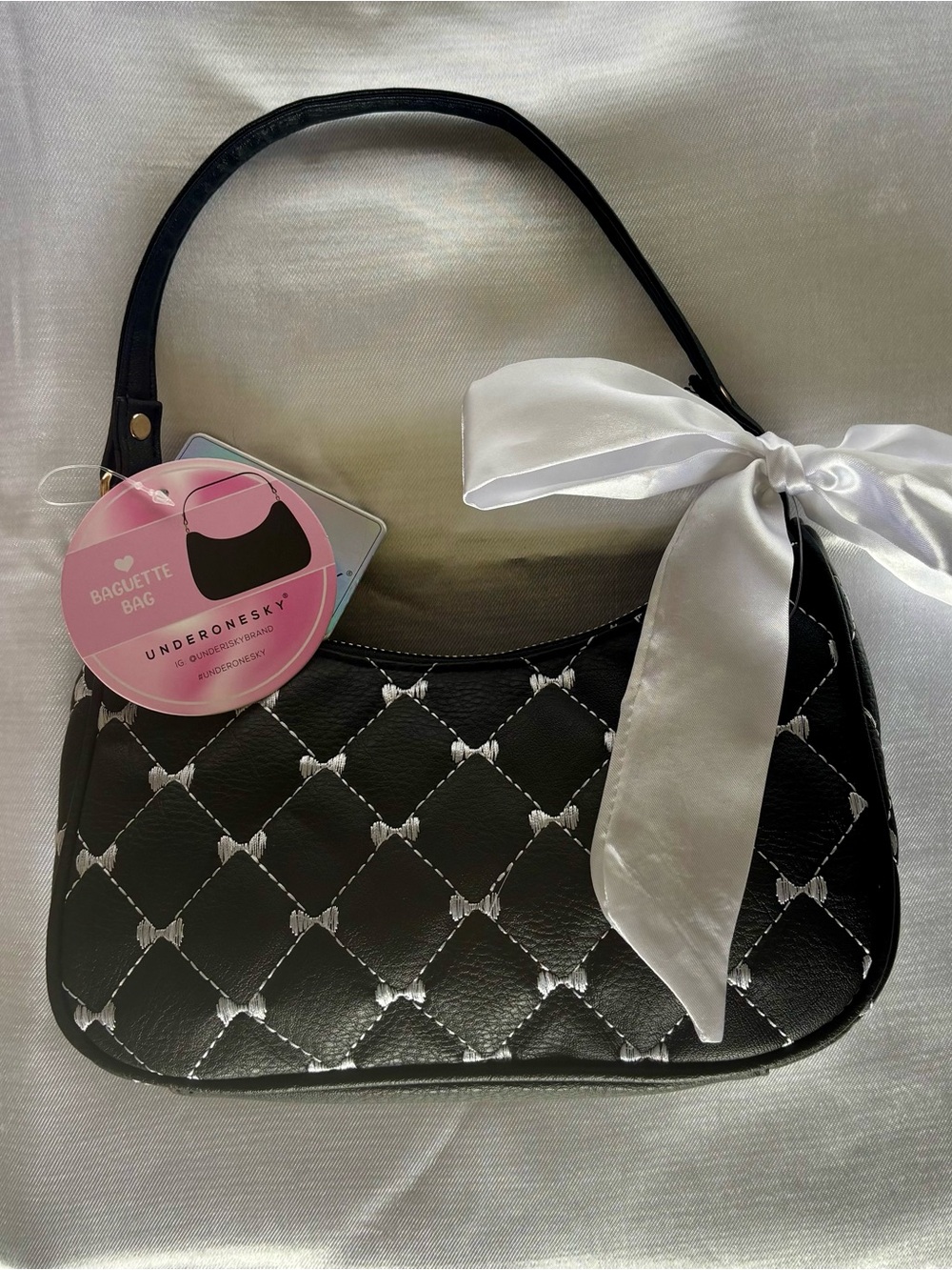 Under One Sky Black Quilted Shoulder Baguette Bag with White Bow Accent